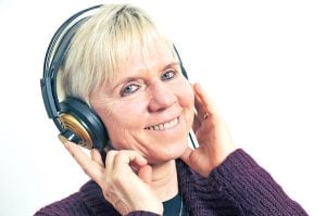 Older woman wearing headphones