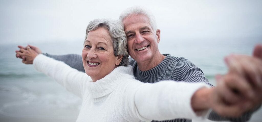 Couple holding hands on a beach