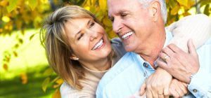 Couple outside hugging and smiling