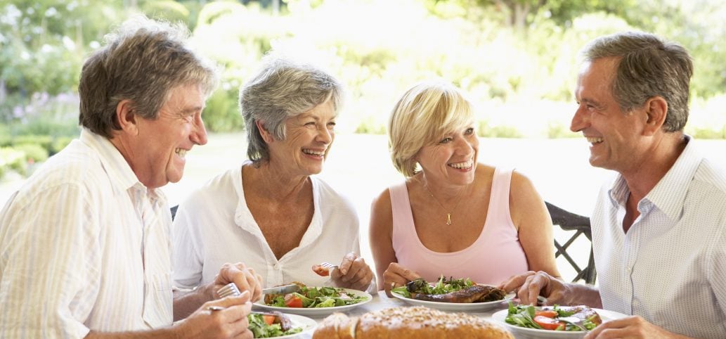 Group of middle aged people eating