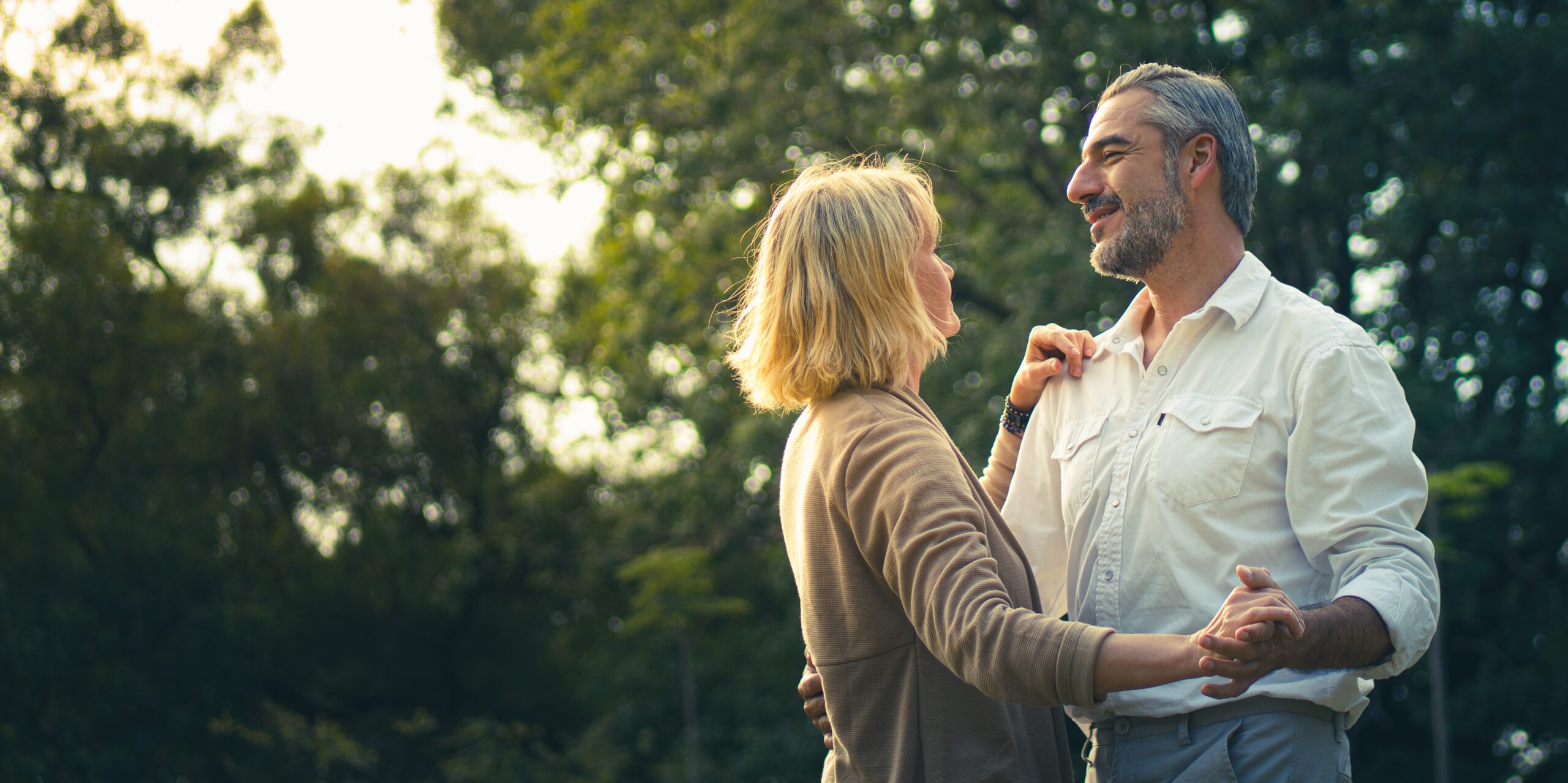 Middle-aged couple dancing outside