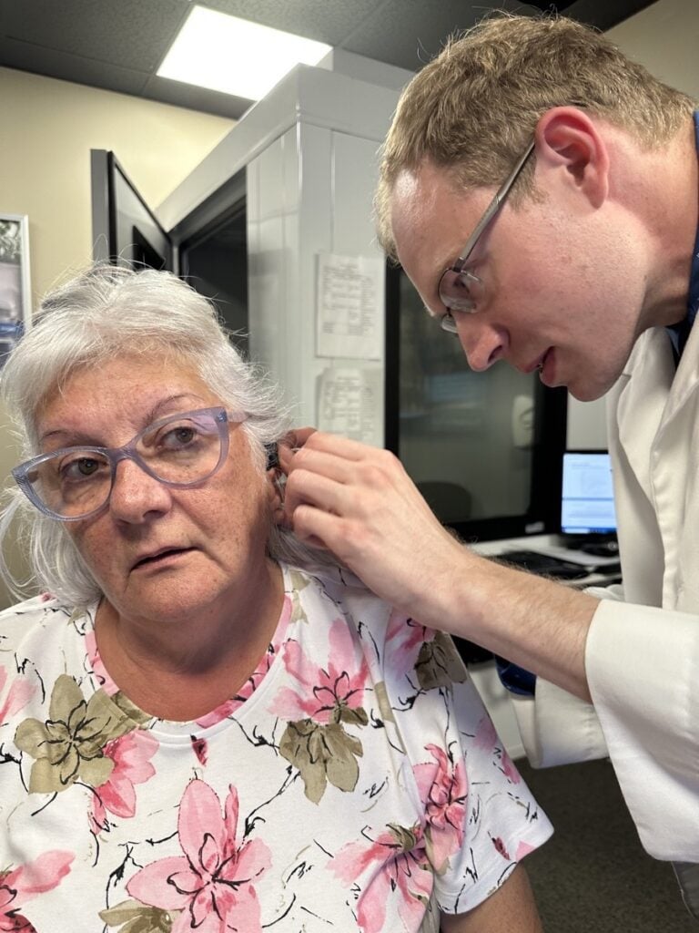 Debbie White receiving gift of hearing