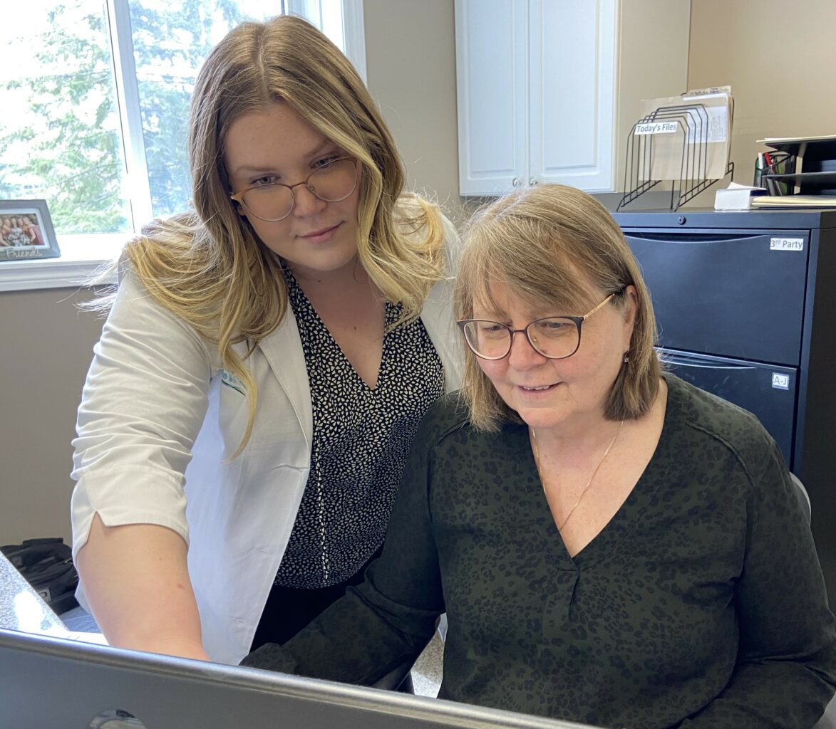 Hearing Instrument Specialists reviewing patient information