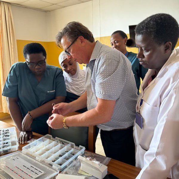 Demonstrating and donating hearing aids to Rwanda